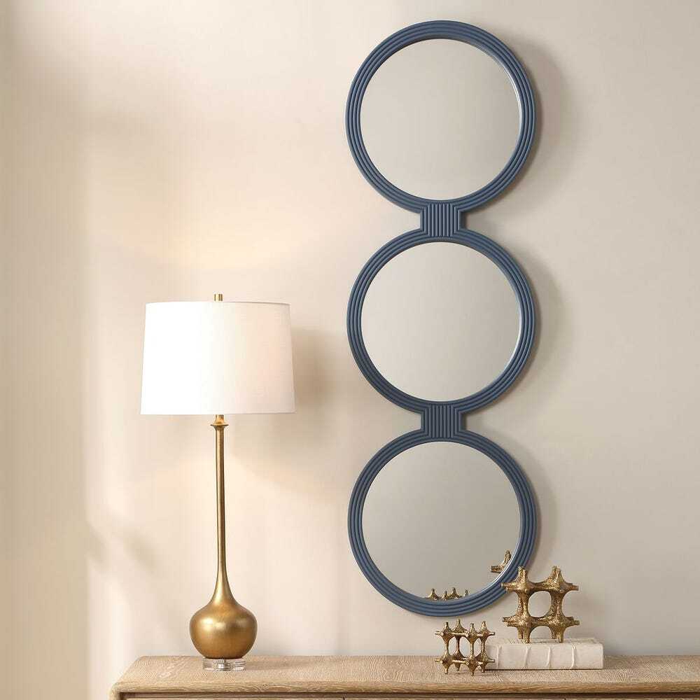 Three interconnected round mirrors, each framed with a continuous ribbed texture in a muted blue-gray finish
