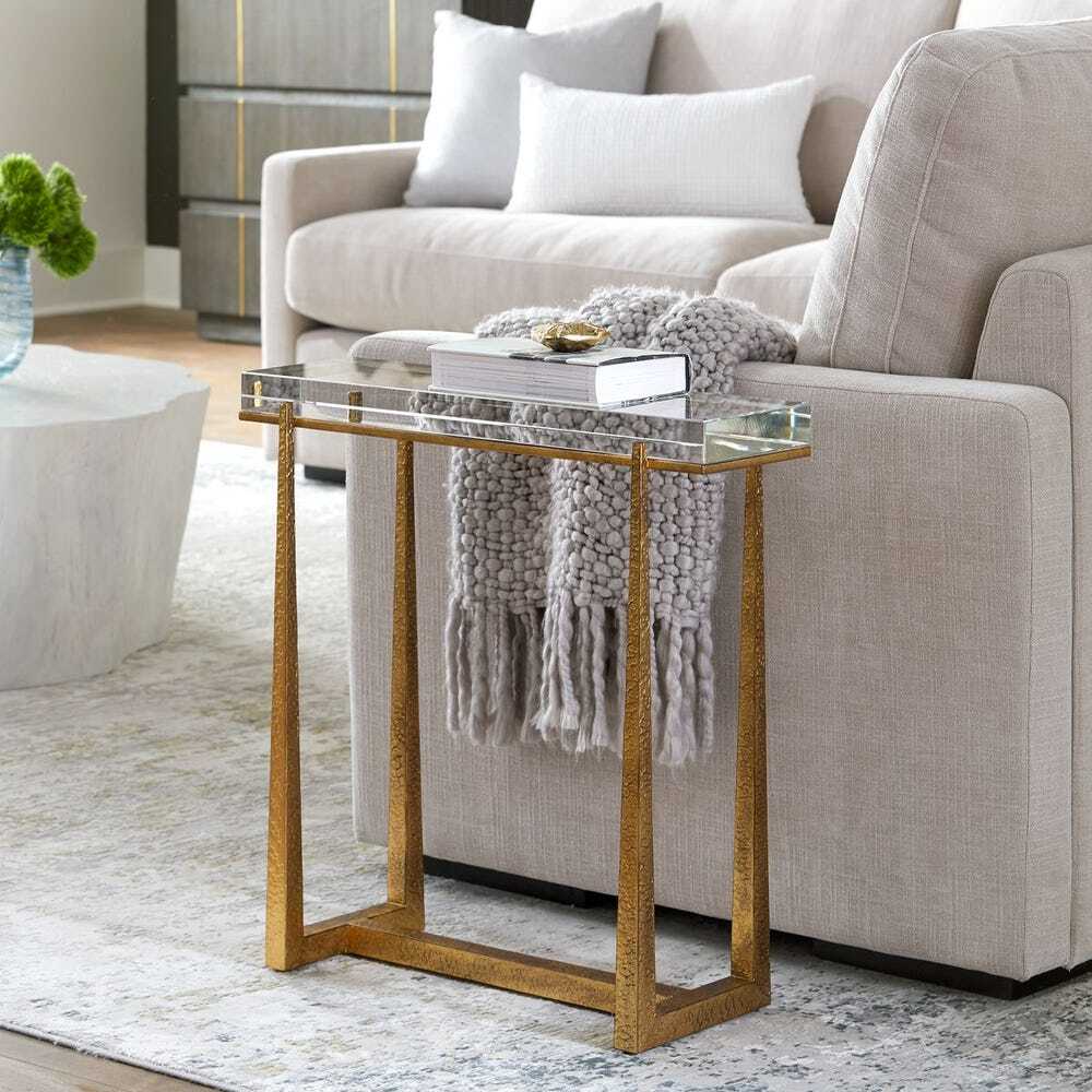 Accent table with textured antique gold finished iron legs with a thick crystal top