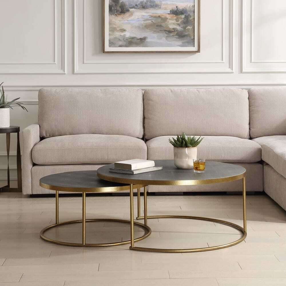 set of two functional nesting tables are constructed with metal bases finished in an antique burnished brass with faux gray shagreen wrapped tops