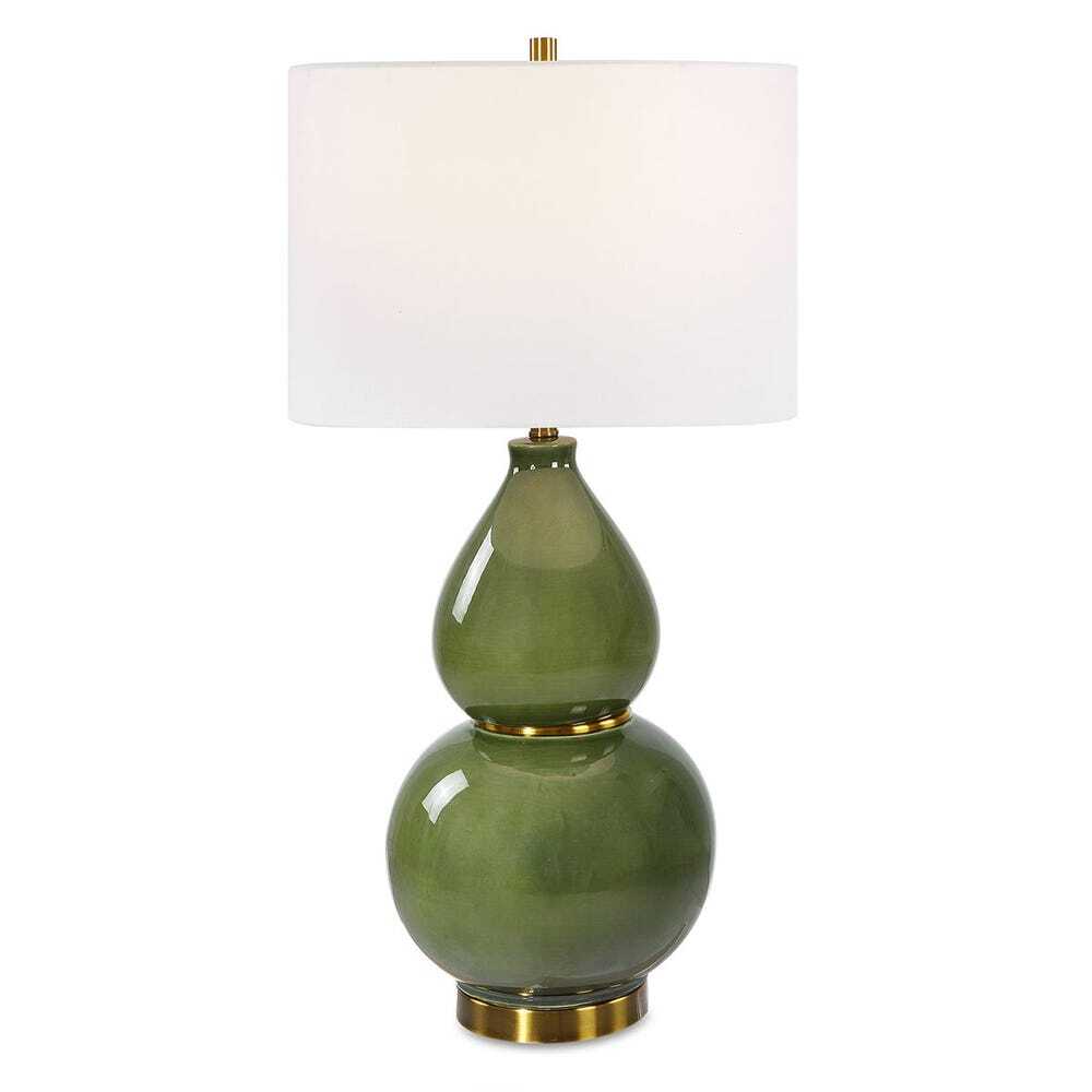 Green ceramic table lamp with white drum shade and gold accents