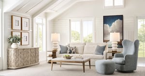 Bright living room featuring white walls and window frames, a white couch, and a gray accent chair.